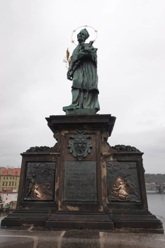 statue of St. John of Nepomuk on Charles Bridge in Prague, Czech Republic