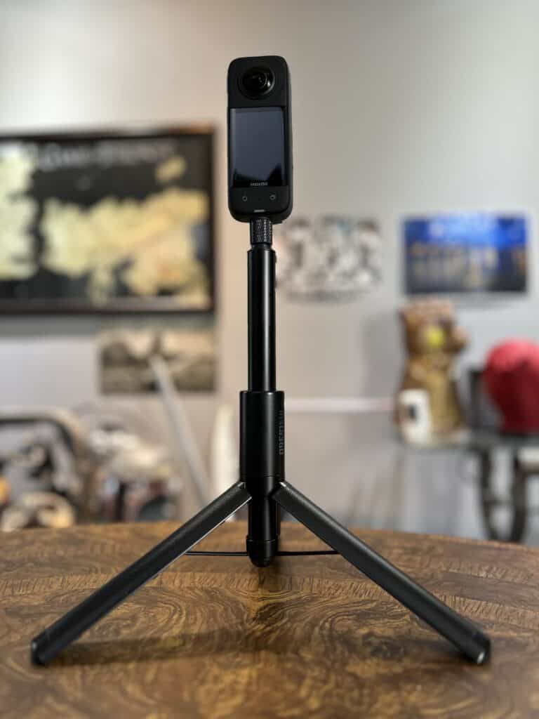 2 in 1 invisible selfie stick with built in tripod- Insta360 X3 mounted on top.