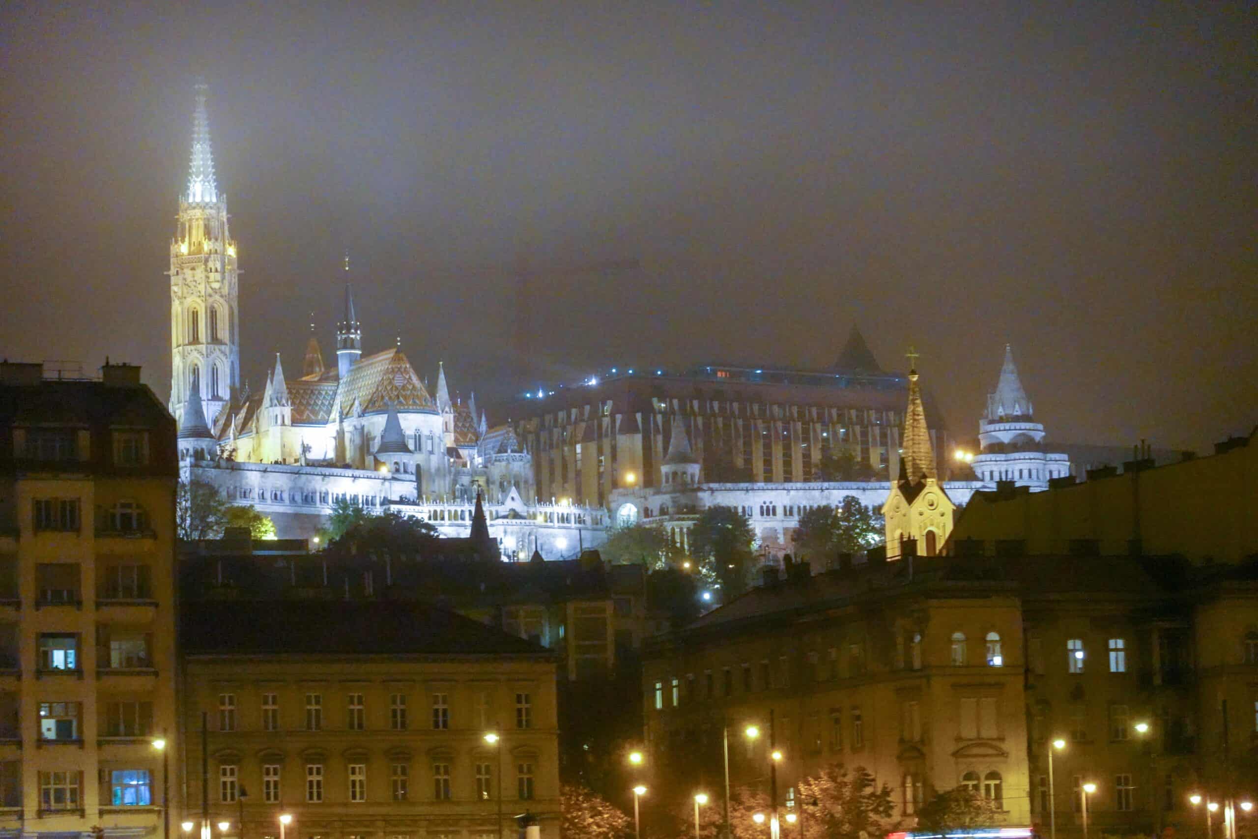 Fisherman's Bastion and multicolored roof of Matthias Church lit up at night in Budapest