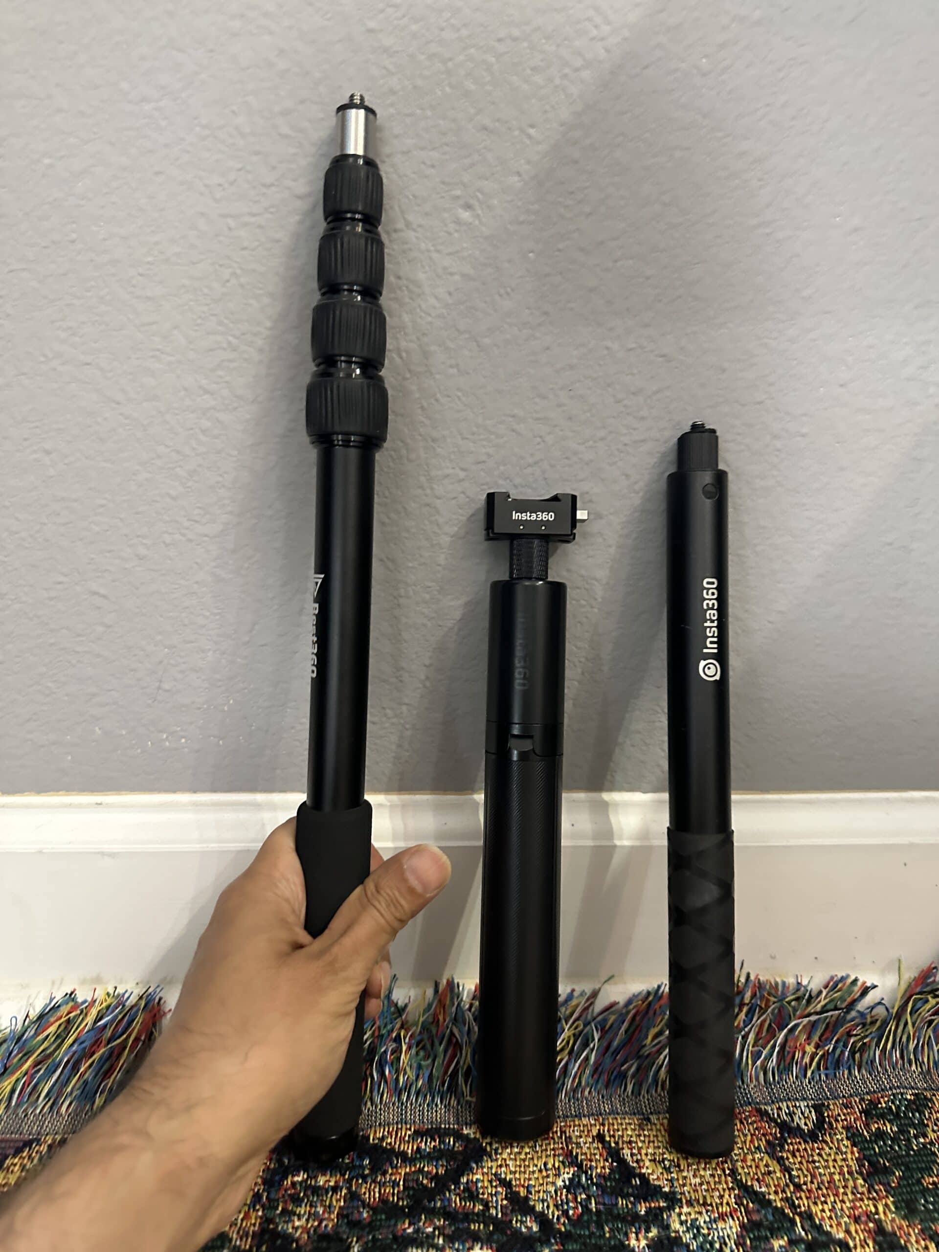 different invisible selfie sticks for your insta360 360 camera. 3 examples retracted against a wall.