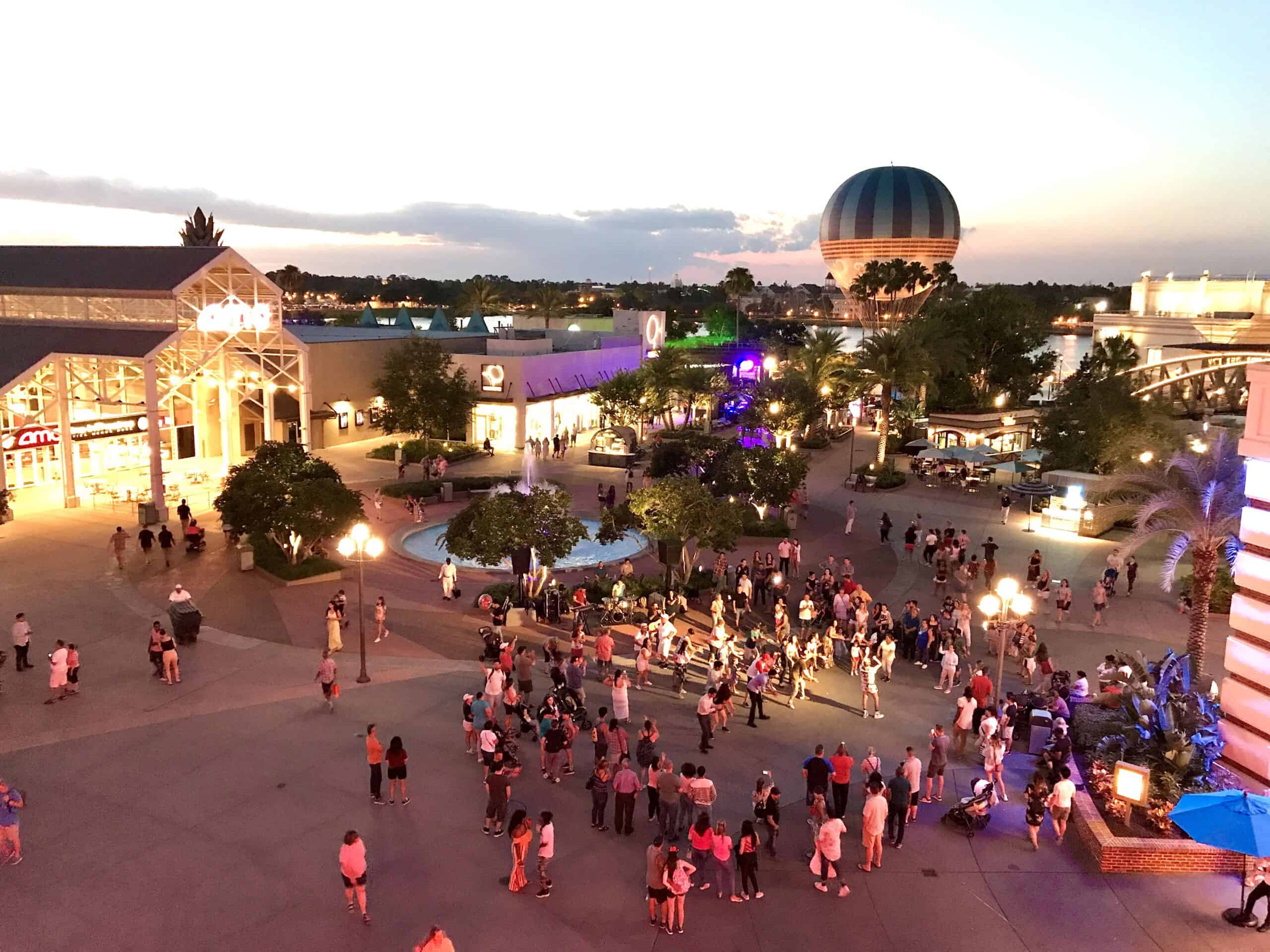 Disney springs Orlando Aerophile and AMC theater at night. Street performer with music and dancing in street