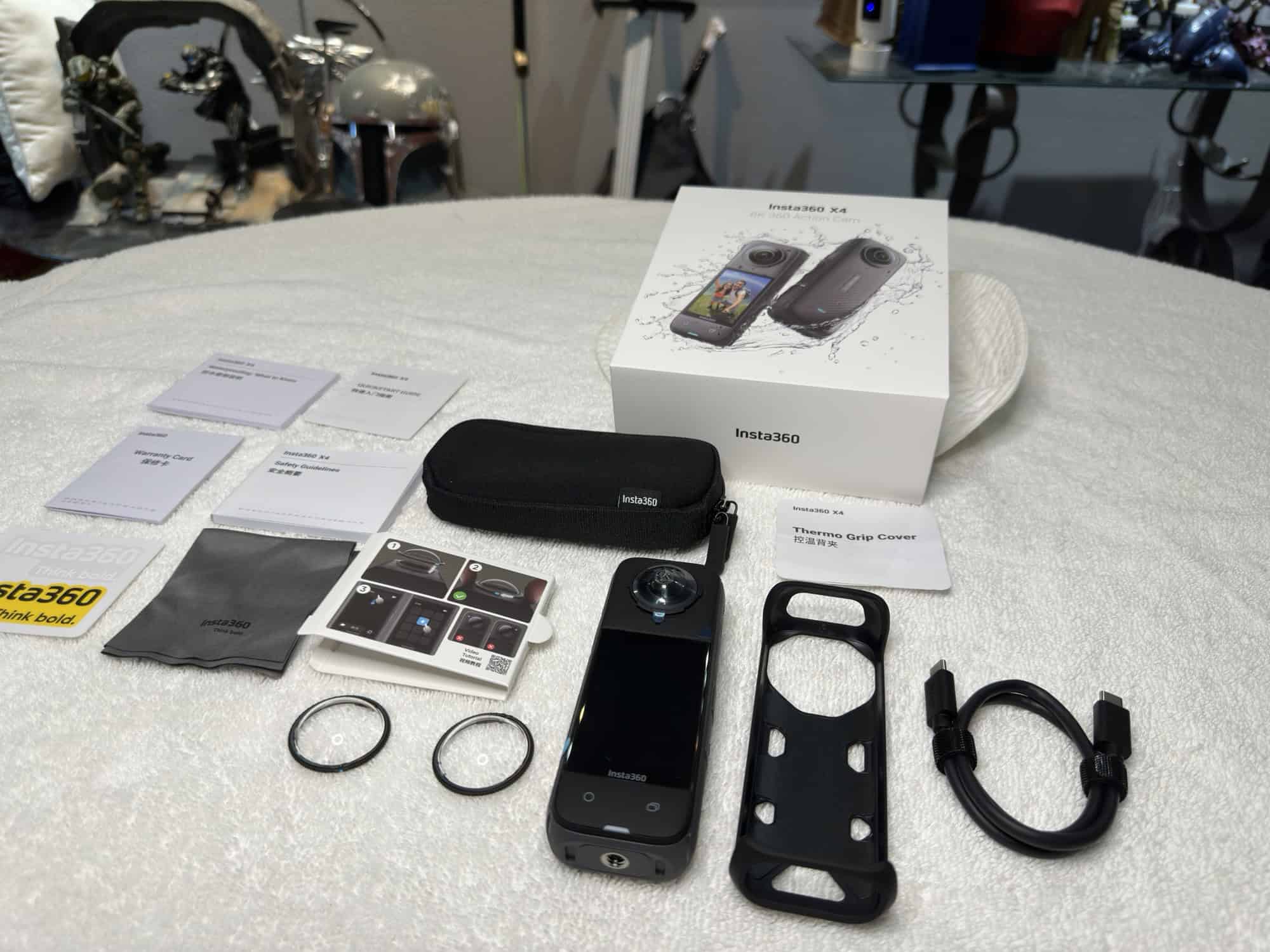 Insta360 X4 unboxed with all the contents laying on table