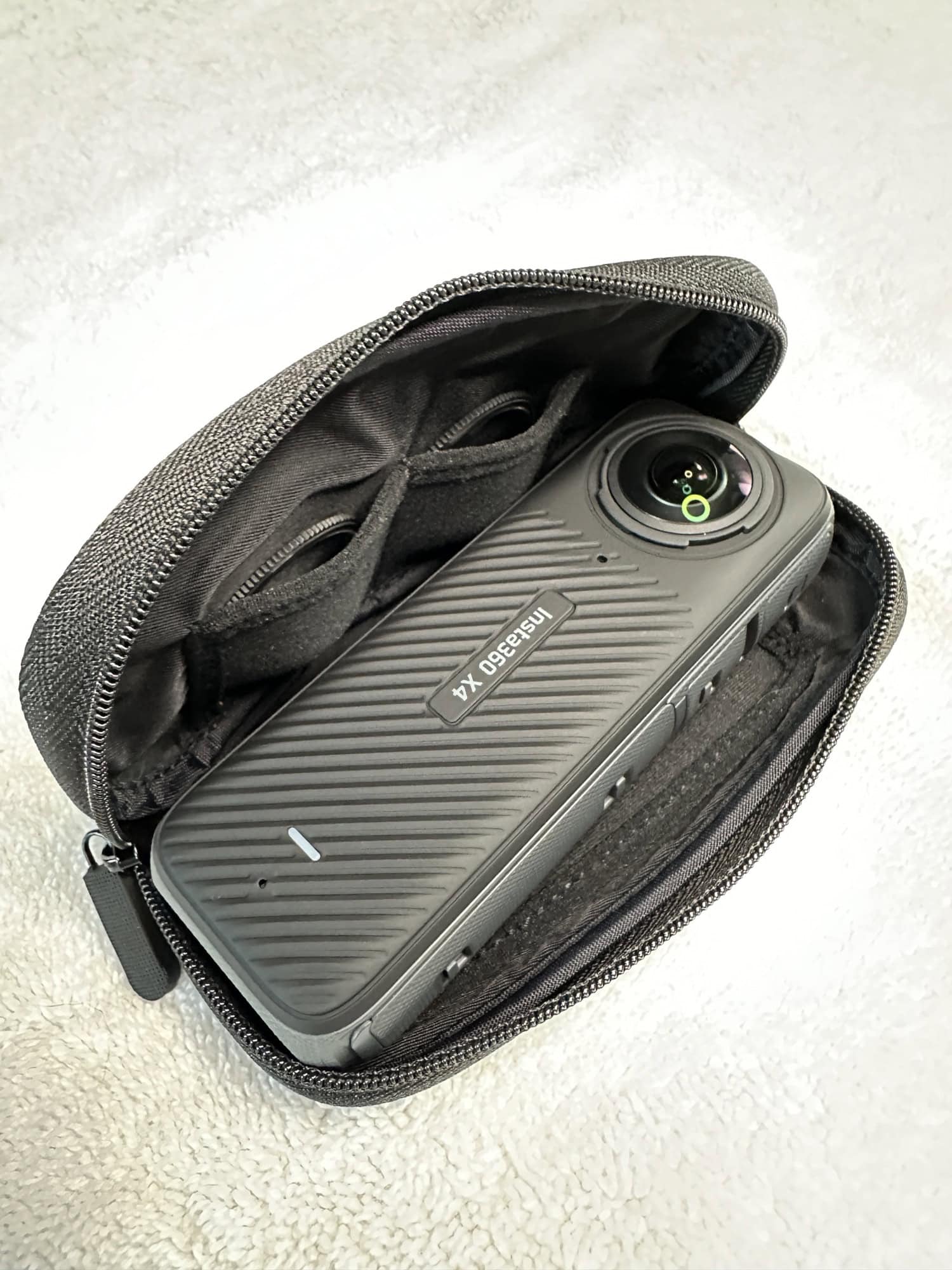 Insta360 X4 in soft case with lens protectors in slots
